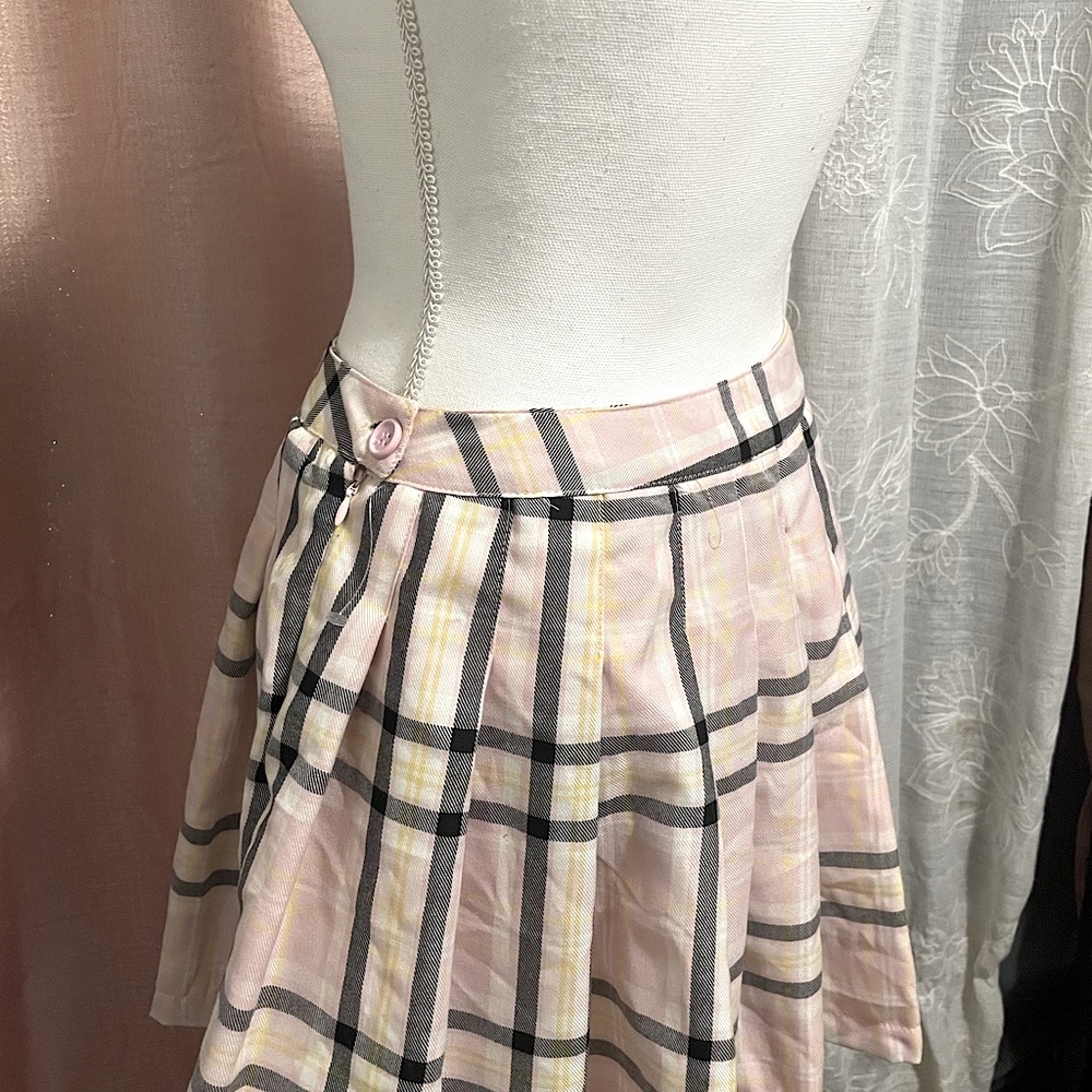 This is a skirt I thrifted and It’s a bright pink with black and a bit of yellow